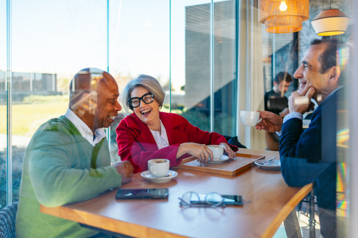 a group of three friends chatting about growing their savings with share certificates at essential credit union in houston
